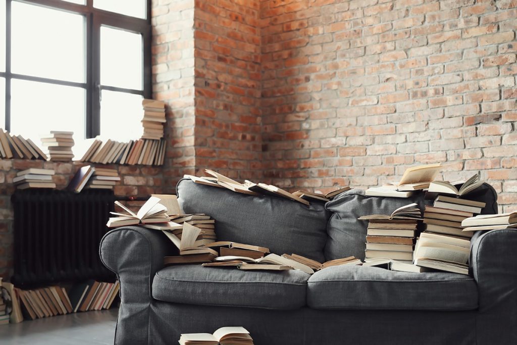 Photo d'un canapé recouvert de nombreux livres